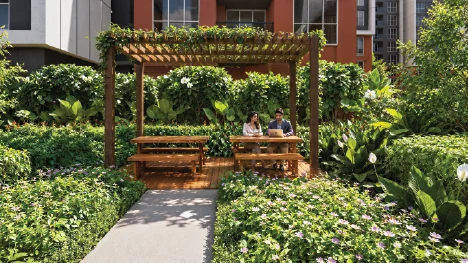 Artist's impression of an outdoor working pod at Godrej Brooklyn Avenue: a timber pergola with bench seating set among dense planting.